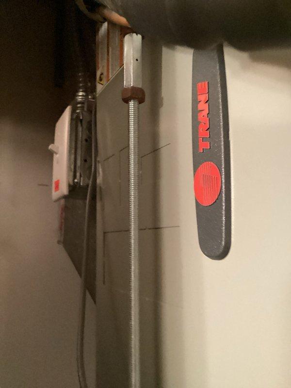 Responded to no cooling complaint on Trane rooftop unit less than 10 years old. Found thermostat calling for cooling with air handler blower operating, but compressor failing to start while condenser fan ran normally. Diagnosed failed run capacitor with multimeter showing open circuit. Replaced defective capacitor, cycled system to verify compressor operation, and confirmed normal refrigerant levels and airflow. System restored to normal cooling operation.