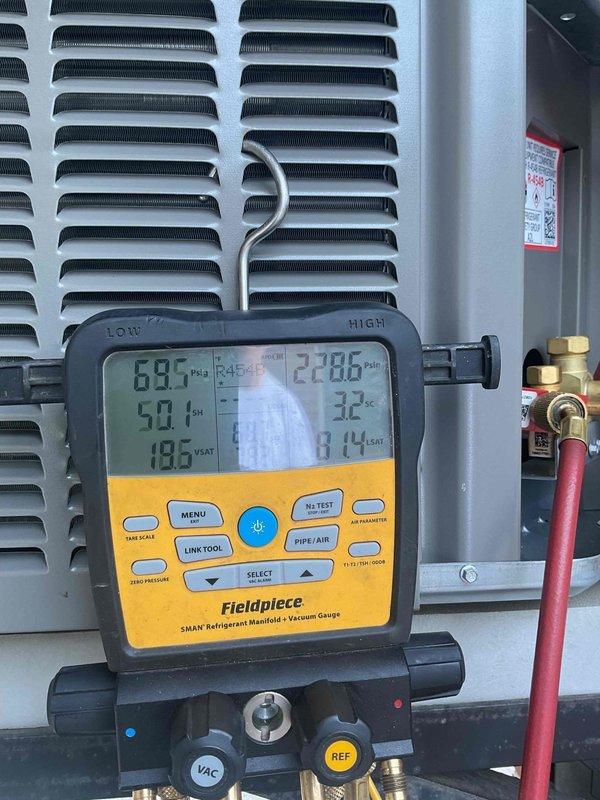 # HVAC Service Completed

Responded to no cooling complaint on residential air conditioning system less than 10 years old. Upon arrival, observed condenser unit short cycling with approximately 10-second run cycles before shutting down. Confirmed system was not providing adequate cooling to structure.

Performed diagnostic evaluation of refrigerant circuit using digital manifold gauges. System pressures indicated critically low refrigerant charge, confirming loss of R-454B refrigerant. Conducted leak inspection of refrigerant lines, coils, and connections. Located refrigerant leak in system requiring repair.

Evacuated remaining refrigerant from system per EPA regulations. Recharged air conditioning system to manufacturer specifications with R-454B refrigerant. Added UV leak detection dye to refrigerant circuit to facilitate future leak identification and monitoring. Verified proper refrigerant pressures on both high and low sides of system using calibrated gauges.

Cycled system throu