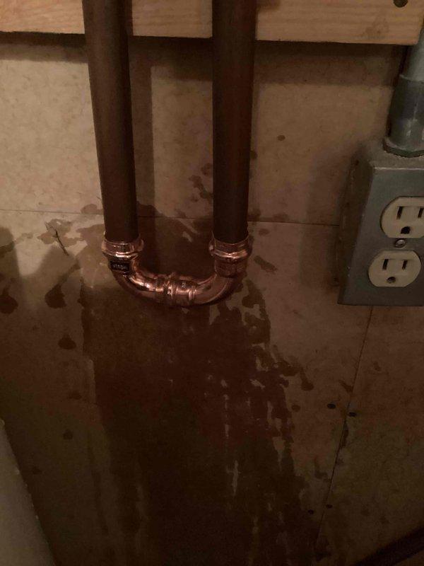 Responded to emergency water leak caused by failed water softener valve that was actively spraying water. Assessed the situation and determined the softener valve was beyond repair. Cut out the malfunctioning water softener unit from the plumbing system and installed a bypass configuration using copper piping to restore water service to the property. The bypass allows continued water flow while preventing further water damage from the compromised softener system.