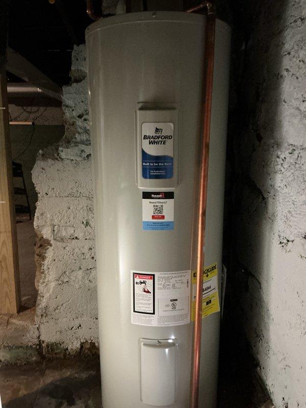Responded to service call for reported water heater making unusual sounds and lack of hot water. Upon inspection of the Bradford White tanked water heater unit, determined the water heater itself was functioning properly with no leaks or mechanical issues present. Investigation revealed the actual source of concern was a failed condensate pump on the adjacent furnace system, which was leaking water in the mechanical room. Removed the old malfunctioning condensate pump and installed a new replacement unit to restore proper HVAC condensate drainage and eliminate the water leak.