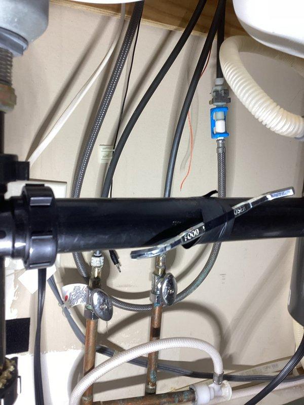 Removed solenoid assembly from kitchen faucet and installed adapter to convert unit to standard configuration using customer-supplied parts. Upon receipt of correct adapter component, completed installation and verified proper operation of faucet system with all water supply connections secure.