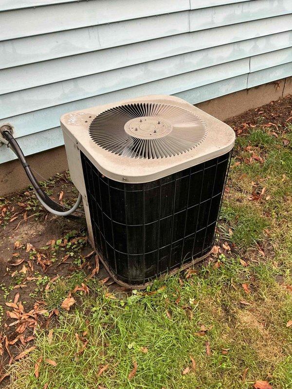 Responded to no cooling complaint on aging outdoor condensing unit. Homeowner reported intermittent buzzing sound when system was called for cooling, followed by unit going quiet with no fan operation. Performed electrical diagnostics and identified failed dual run capacitor preventing compressor and condenser fan motor from starting. Discussed findings with homeowner who authorized capacitor replacement. Installed new capacitor, verified proper voltage and amperage readings on compressor and fan motor, and tested all electrical components for proper operation. Performed courtesy condenser coil rinse to remove debris and improve heat transfer efficiency. Cycled system through complete cooling cycle and confirmed outdoor unit now operating properly with normal cooling restored to home.