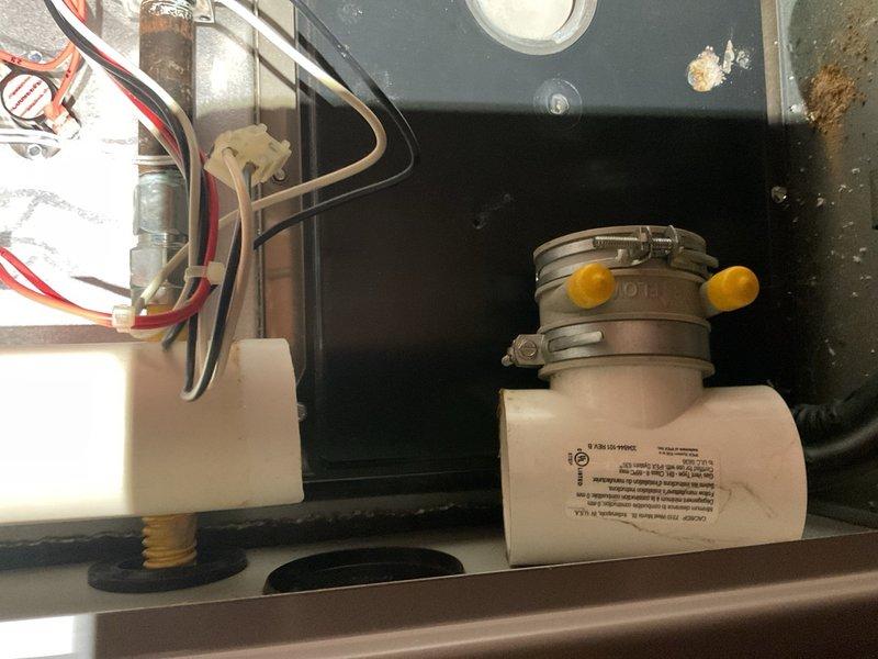 Responded to no-cooling complaint on 15-year-old system with outdoor fan running but no indoor cooling. Diagnosed and replaced failed 30/5 µF dual-run capacitor reading 0 µF, restoring air conditioning operation. Verified R-22 refrigerant charge operating within proper parameters. Performed furnace inspection revealing loose PVC vent elbow collar; resecured and glued connection to prevent exhaust leakage. Removed accumulated powder residue from inducer housing area and inspected heat exchanger and collector box for cracks—none found. Confirmed furnace heating operation functioning properly. Advised that both the 2005 air conditioning unit and 2010 Tempstar furnace are nearing end of expected service life and should be monitored closely for future reliability concerns.