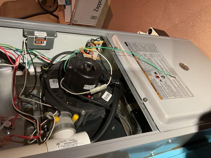 Responded to no-cooling complaint on 15-year-old system with outdoor fan running but no indoor cooling. Diagnosed and replaced failed 30/5 µF dual-run capacitor reading 0 µF, restoring air conditioning operation. Verified R-22 refrigerant charge operating within proper parameters. Performed furnace inspection revealing loose PVC vent elbow collar; resecured and glued connection to prevent exhaust leakage. Removed accumulated powder residue from inducer housing area and inspected heat exchanger and collector box for cracks—none found. Confirmed furnace heating operation functioning properly. Advised that both the 2005 air conditioning unit and 2010 Tempstar furnace are nearing end of expected service life and should be monitored closely for future reliability concerns.