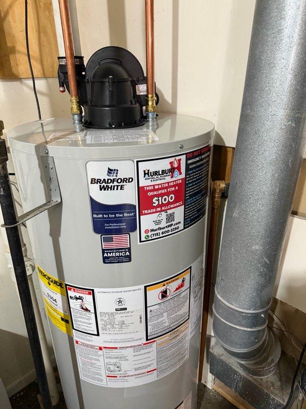 Responded to no hot water complaint at residential property. Upon inspection, found existing water heater leaking from bottom of tank, which caused startup failure and complete loss of hot water supply throughout home. Due to extent of tank failure and safety concerns, determined replacement was necessary. Removed and properly disposed of failed unit. Installed new Bradford White 50-gallon natural gas power vent water heater in utility room. Connected all water supply lines using copper piping with brass fittings, installed yellow-jacketed natural gas line, and configured PVC venting system for power vent exhaust. Verified all connections for proper operation and tested unit for leaks. System fired successfully and began heating water. Confirmed hot water restoration throughout home before completing service.