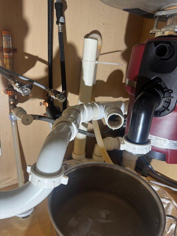 Responded to a backed-up kitchen sink that was overflowing into the cabinets. Upon arrival, accessed the drain line beneath the sink and utilized a RIDGID flex-shaft machine to clear the blockage. Removed significant accumulation of grease and hair from the kitchen drain line, restoring proper drainage and flow to the sink.