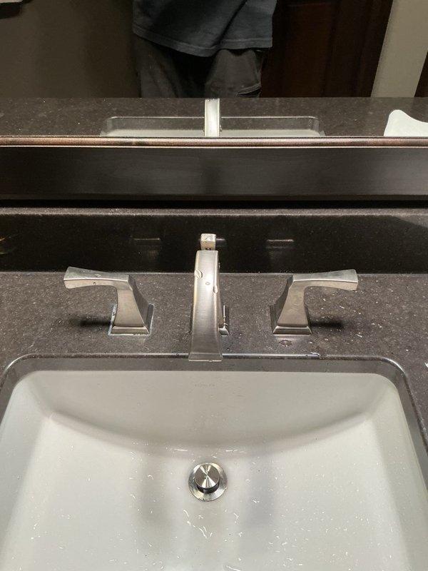 Installed customer-supplied widespread faucet with brushed nickel finish on bathroom vanity with undermount sink. Removed existing faucet assembly, prepared mounting surface, and installed new three-piece faucet set including central spout and dual lever handles. Verified proper water flow, checked for leaks, and ensured all connections were secure and functioning correctly.