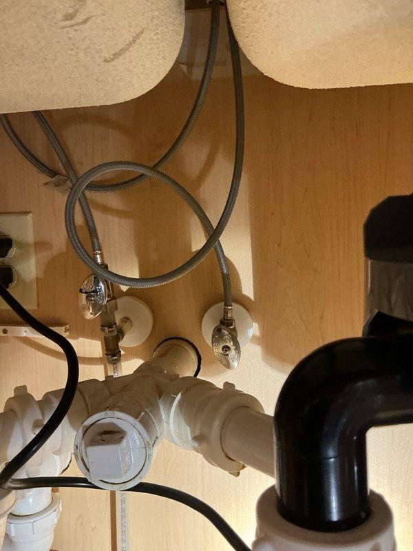Responded to service call for leaking kitchen faucet with water dripping from the spray head assembly. Removed existing defective faucet and installed customer-supplied replacement kitchen faucet unit. Connected new braided stainless steel supply lines to existing shut-off valves and verified all connections were secure and leak-free. Tested water flow and drainage system to ensure proper operation of new faucet installation.