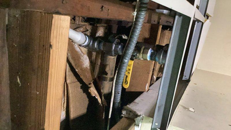 Responded to a broken baseboard heating line in the rear of the property. Drained down the hydronic heating system and accessed the damaged piping by cutting into the main level flooring near the existing radiator. Rerouted the supply piping using PEX tubing and installed ball valves for future serviceability. Replaced the radiator valve and made new connections to restore flow. During the repair, discovered the return piping would not separate as planned due to seized fittings. System was left in a drained and de-energized state pending return visit with replacement fittings to complete the return line connection. Restoration work for flooring repair will require separate contractor. A permit may be required for this repiping work.