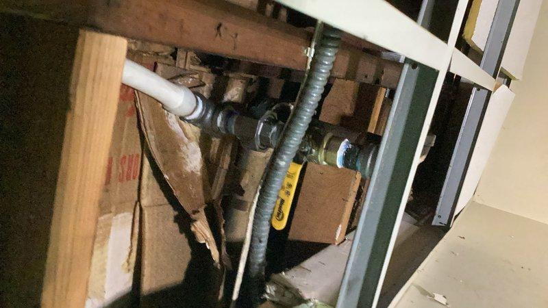Responded to a broken baseboard heating line in the rear of the property. Drained down the hydronic heating system and accessed the damaged piping by cutting into the main level flooring near the existing radiator. Rerouted the supply piping using PEX tubing and installed ball valves for future serviceability. Replaced the radiator valve and made new connections to restore flow. During the repair, discovered the return piping would not separate as planned due to seized fittings. System was left in a drained and de-energized state pending return visit with replacement fittings to complete the return line connection. Restoration work for flooring repair will require separate contractor. A permit may be required for this repiping work.