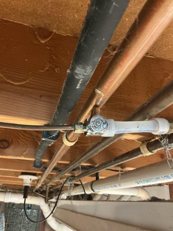 Responded to service call for non-functional refrigerator shut-off valve preventing water supply isolation for appliance replacement. Accessed plumbing infrastructure in basement ceiling space and located existing refrigerator supply line valve. Removed failed shut-off valve from copper water supply line and installed new chrome valve assembly with proper fittings. Tested new valve for proper operation and verified complete water shut-off capability. Customer now able to proceed with new refrigerator installation.