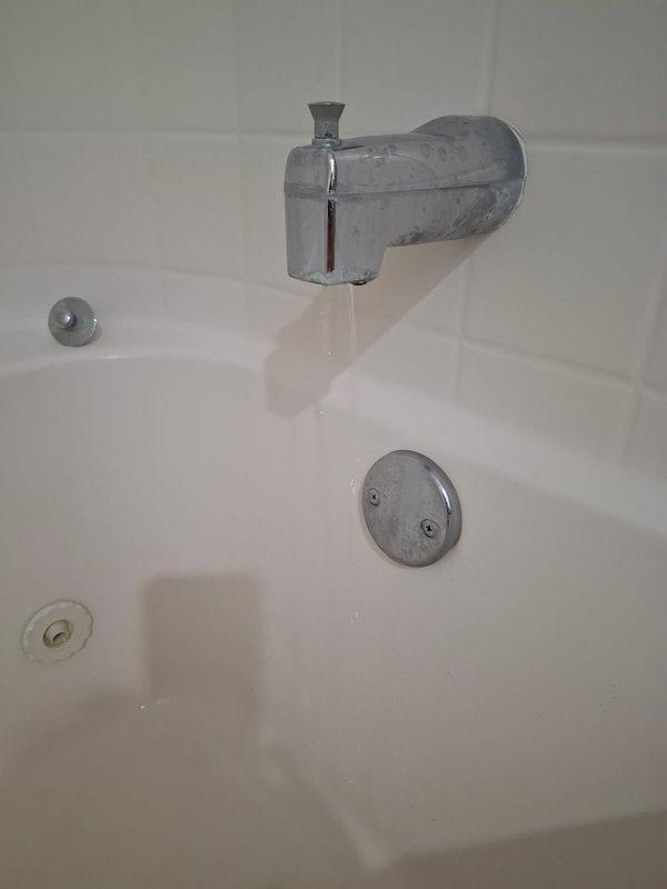 Responded to service call for multiple faucet issues including a severely leaking bathtub faucet that was streaming water when turned off, and reduced hot water pressure at the kitchen sink. Diagnosed failed Moen cartridge in the tub faucet assembly and successfully replaced the cartridge, restoring proper shut-off function and eliminating the continuous water flow. Addressed kitchen sink concern where a black cap had been inadvertently left on during previous installation, contributing to reduced hot water pressure and extended wait times for hot water delivery.