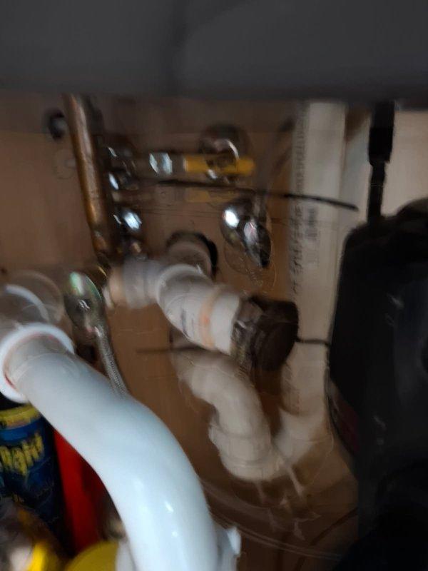 Responded to service call for multiple faucet issues including a severely leaking bathtub faucet that was streaming water when turned off, and reduced hot water pressure at the kitchen sink. Diagnosed failed Moen cartridge in the tub faucet assembly and successfully replaced the cartridge, restoring proper shut-off function and eliminating the continuous water flow. Addressed kitchen sink concern where a black cap had been inadvertently left on during previous installation, contributing to reduced hot water pressure and extended wait times for hot water delivery.