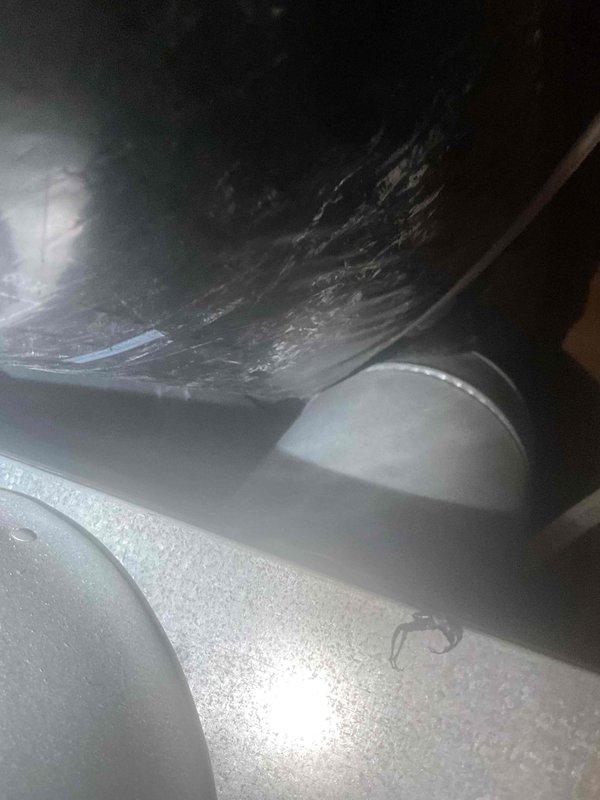 Responded to service call for detached flexible ductwork filled with leaves and debris. Upon inspection, found fresh air intake duct had become disconnected and was hanging loose. Removed accumulated leaves and debris from ductwork, then reconnected and secured the flexible duct back into proper position. System interior showed dust accumulation consistent with compromised ductwork allowing outdoor contaminants to enter. Recommended future cleaning and potential duct sealing to prevent recurrence.