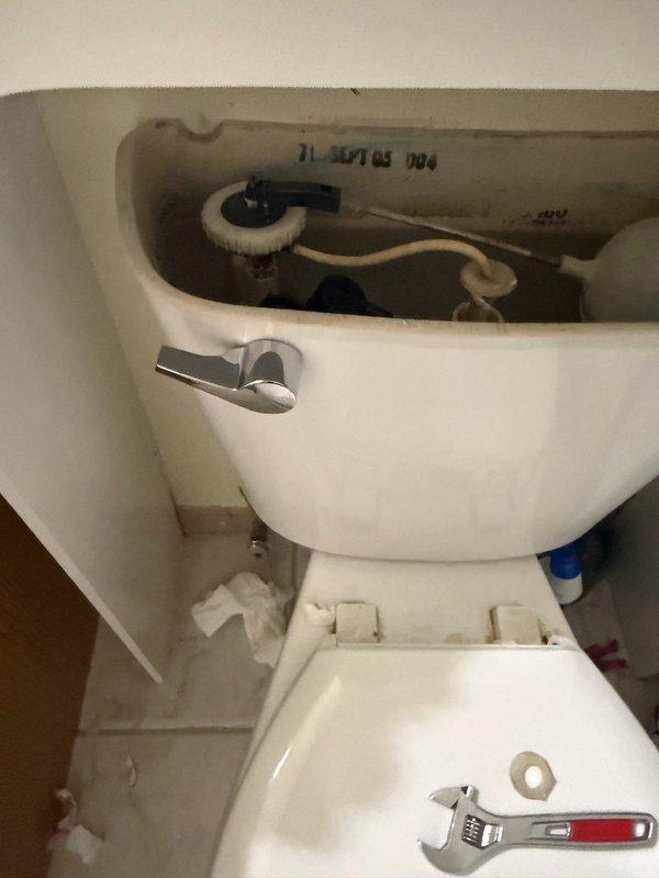 Responded to commercial toilet service call for non-functional flush handle. Upon inspection, found the trip lever mechanism inside the tank had failed, preventing proper toilet operation. Removed tank lid, assessed internal components, and successfully replaced the broken trip lever assembly with new hardware. Tested flush mechanism to ensure proper operation and restored toilet to full working condition.