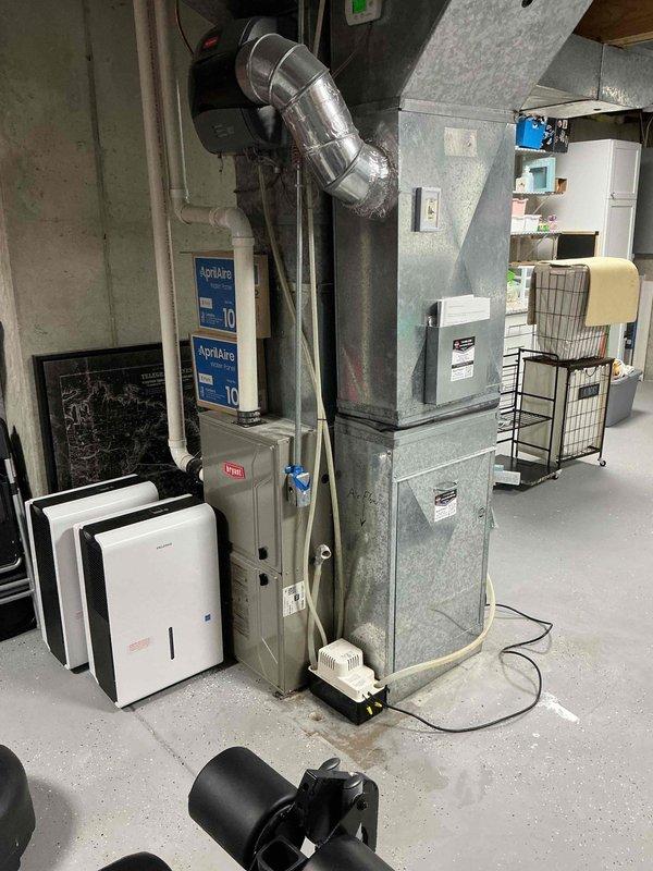 Responded to water leaking issue near furnace system. Found condensate pump overflowing onto basement floor due to plugged pump mechanism and blocked drain line. Cleaned condensate pump assembly and flushed drain line to restore proper drainage function. System tested and confirmed operational with no further water accumulation.