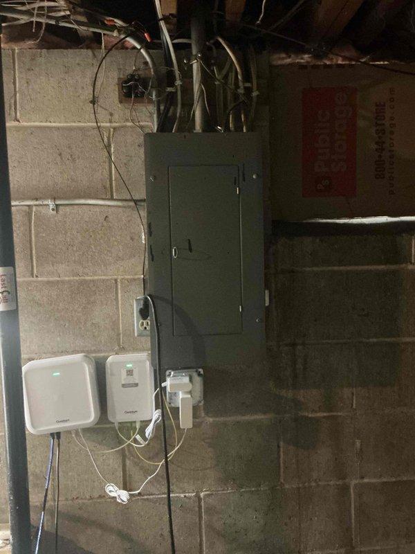 Responded to no-cool complaint on 20+ year old Lennox air conditioning system with water leak at furnace base. Found evaporator condensate drain line completely blocked at drain pan, causing water accumulation. Successfully cleared blockage and verified proper drainage pathway to floor drain. Performed comprehensive system evaluation and discovered inadequate temperature drop across evaporator coil at approximately 12 degrees, indicating cooling deficiency. Upon attempting refrigerant pressure diagnostics, discovered active refrigerant leak at service port Schrader valve with R22 refrigerant escaping, confirming low charge condition. Explained that R22 refrigerant has been phased out and refrigerant-side repairs are no longer performed on legacy systems. Discussed system replacement options and available consultation services for equipment upgrade planning. Customer requested time to consider recommendations. Photos documented existing HVAC equipment configuration and electrical infras