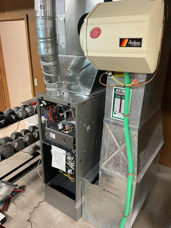 Completed installation of SL280V 80% AFUE, 2-stage, variable speed upflow furnace rated at 70,000 BTU in basement utility area. Installation included adapting existing venting and gas lines, installing return air drop, reusing existing thermostat, and installing 16x25x1 filter. Disconnect switch required reinstallation to meet code requirements; reinstalled disconnect switch, energized system, and verified proper operation. All components tested and confirmed operational, including humidifier integration and electrical connections at main panel.