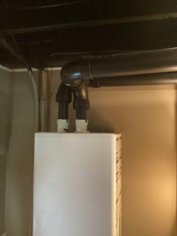 Responded to callback for gas odor complaint at residence where water heater was previously installed. Upon inspection, identified gas leak occurring through exhaust vent during unit operation. Diagnostic testing confirmed water heater was over-firing, causing combustion gases to escape through the exhaust system rather than venting properly. Documented mechanical components including gas valve assembly, control wiring, and venting configuration with photographs for further evaluation. Unit requires combustion analysis and gas pressure adjustment by certified technician to correct over-firing condition and ensure safe operation within manufacturer specifications.