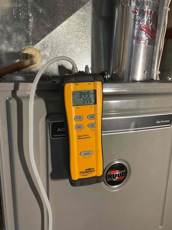 Performed comprehensive HVAC tune-up and system inspection on Ruud gas furnace unit. Conducted thorough equipment check-up including pressure diagnostics using digital manometer, with readings of 349 and 355 recorded for system performance verification. Inspected all major components including ductwork, copper refrigerant lines, air handler assembly, and gas connections. All equipment found to be operating within normal parameters with no issues identified or repairs required.