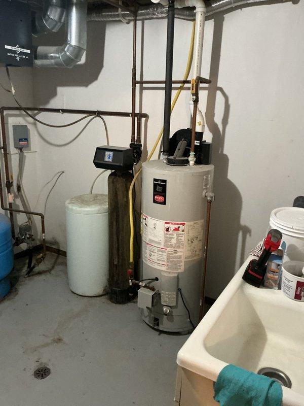 Performed comprehensive inspection and maintenance on tanked water heater system over 10 years old. Completed full flush of water heater to remove sediment buildup and restore optimal heating efficiency. Conducted water quality testing and thorough inspection of water softener system to ensure proper operation of all components. Verified all plumbing connections, pressure tank, and associated equipment were functioning correctly.