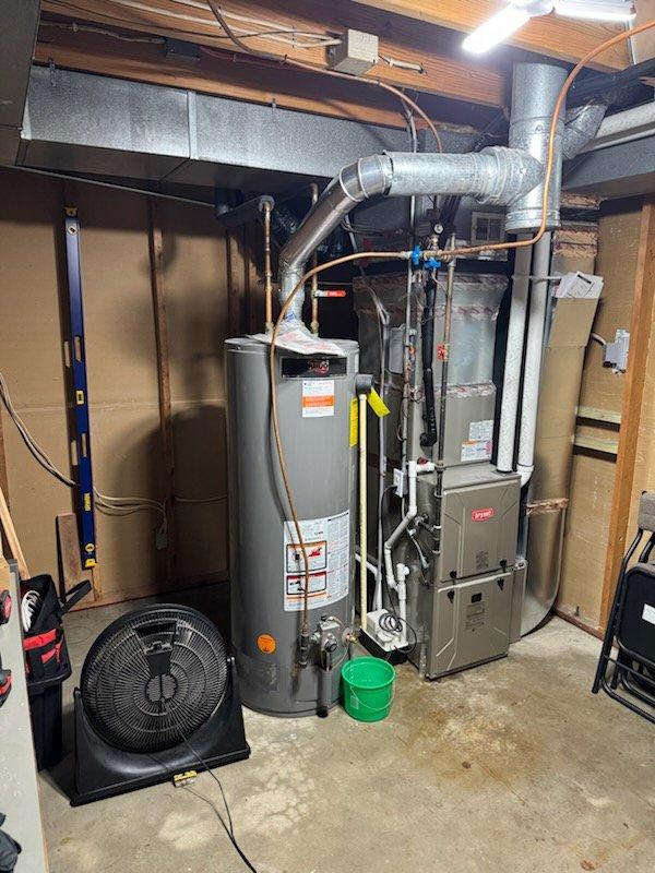 Responded to a water heater emergency involving a failed 50-gallon natural gas unit that had leaked and caused several inches of water accumulation in the basement. Removed and disposed of the existing failed water heater, installed a new 50-gallon natural gas standard water heater with proper venting and gas connections, and tested all systems to ensure proper operation and no leaks.