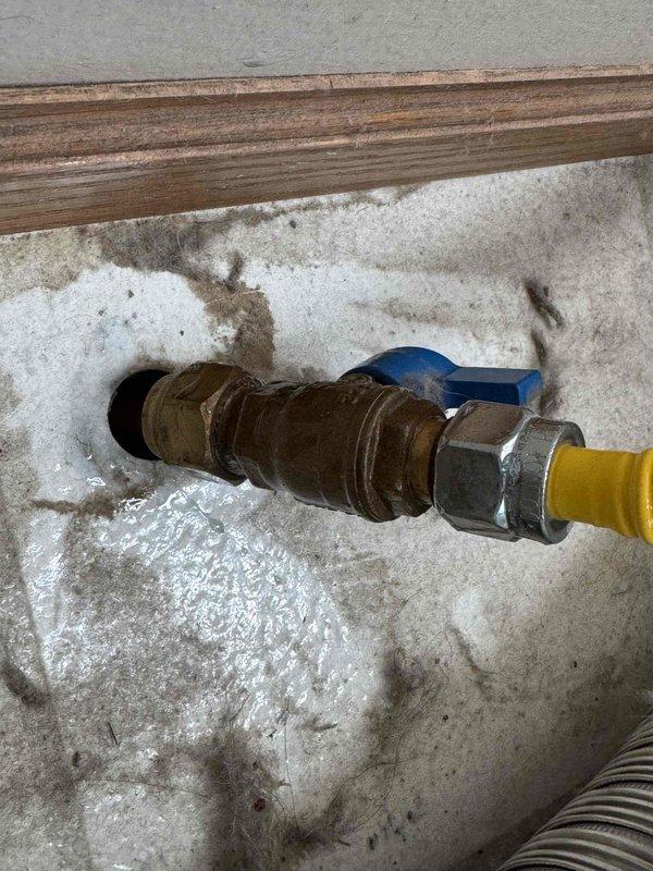 Responded to report of strong gas odor near dryer and immediately shut off gas supply as a safety precaution. Inspected gas piping to dryer and identified active leak at corroded copper fitting connection. Disconnected the faulty fitting, cleaned the connection surfaces, reassembled, and properly tightened to manufacturer specifications. Restored gas service and performed bubble test verification to confirm leak was successfully eliminated and system was safe for operation.