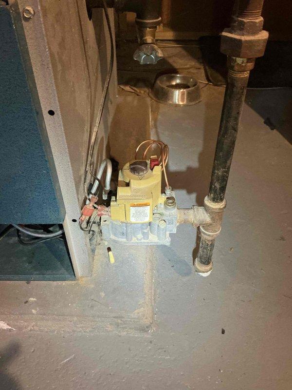 Completed annual furnace inspection on 30+ year old Utica boiler system. Performed comprehensive evaluation including piping integrity, venting condition, backflow preventer, pressure relief valve, system pressure levels, burner cleanliness, and expansion tank operation. Conducted combustion analysis and carbon monoxide testing at heat exchanger seals with satisfactory results. Verified all radiators heating properly throughout system. 

Inspection camera revealed significant corrosion on cast iron heat exchanger, particularly severe on right side of unit. Corrosion presents potential safety hazard as deteriorating sections could detach and fall onto burner assembly during operation. Documented findings with thermal imaging and interior inspection photographs showing mineral deposits and metal deterioration on ribbed heat exchanger surfaces. All other system components including gas valve, copper connections, and piping connections found in acceptable working condition with normal wear