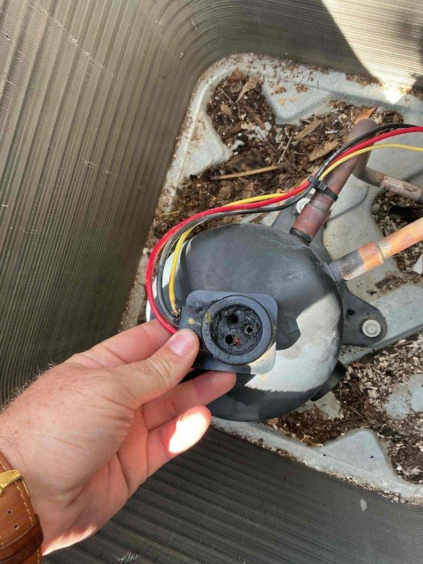 Responded to no cooling complaint on 4-year-old Lennox air conditioning system with condenser tripping breaker immediately upon startup. Diagnosed melted wiring harness causing repeated breaker trips. Performed compressor winding resistance testing using digital multimeter, confirming all windings intact and operational. Identified pitted compressor terminal that would prevent proper long-term connection with standard OEM wiring harness replacement. Recommended terminal repair kit installation in conjunction with new wiring harness to ensure secure electrical connections and prevent future failure. Submitted parts request for customer estimate.