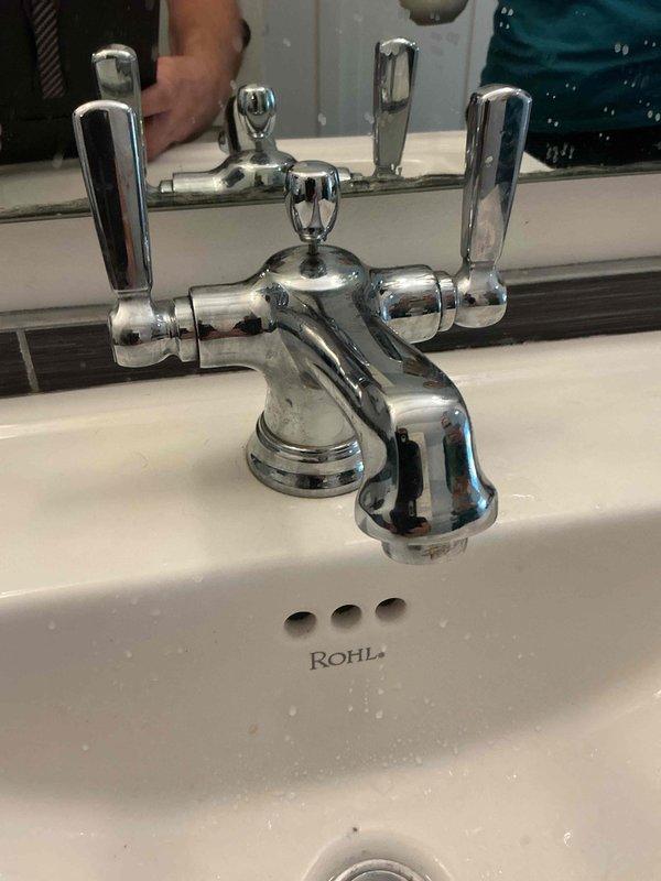 Responded to a low water pressure complaint affecting a bathroom sink with ROHL fixtures and chrome-plated faucet. Upon inspection, diagnosed the issue as a clogged aerator restricting water flow through the faucet spout. Ordered an aerator key tool to properly remove and service the aerator assembly for this fixture.