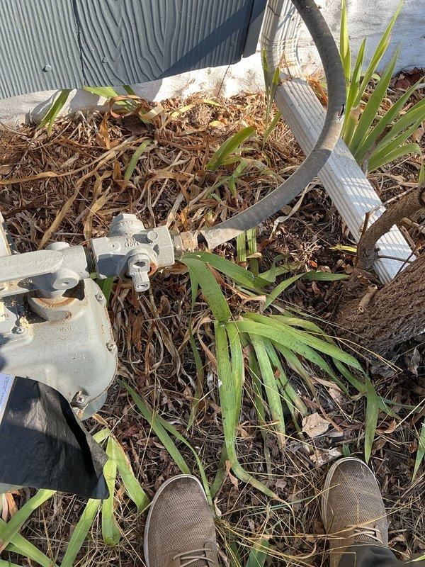 Responded to gas leak emergency on 1-year-old HVAC system where private gas line was damaged by chainsaw during yard work. Upon arrival, confirmed gas meter had been locked and tagged out by Xcel Energy Cooperative due to active leak in 3/8" copper gas line. Performed thorough inspection and documentation of the damaged line, which showed visible breach in the copper tubing near the HVAC unit exterior. Photographed damage site showing compromised gas line section among landscaping area with mulch and vegetation. System was non-operational due to gas supply shutoff for safety. Ordered replacement parts for copper gas line repair and scheduled return visit for permanent repair once materials arrive. Ensured site remained safe and secure with utility lockout in place.