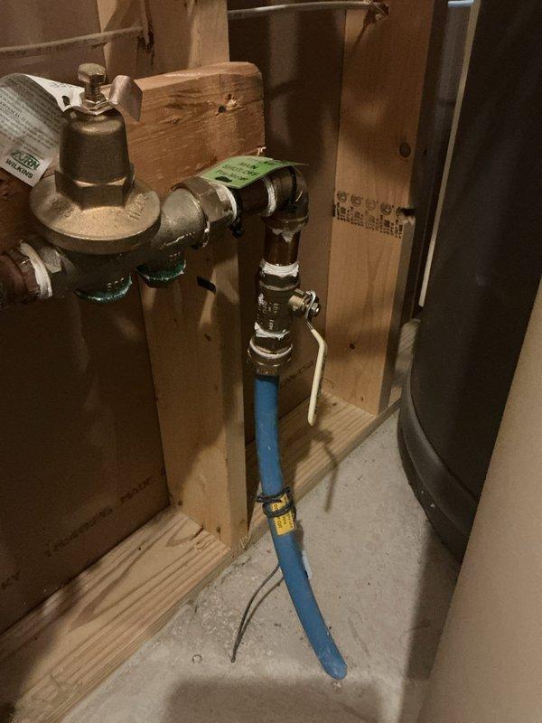 Responded to a service call for a seized ball valve located in the basement before the water meter. Upon inspection, found the main water valve stuck in a partially open/closed position with concerns about a potentially frozen city water main, though no active leaks were present at the time of service. Attempted to remedy the situation by replacing the valve handle, but these efforts were unsuccessful due to the valve being completely seized. Assessed the pressure reducing valve assembly and associated plumbing connections, which included brass fittings and PEX supply lines mounted on the basement framing. Documented the existing plumbing configuration with photographs showing the pressure reducing valve, ball valve assembly, and flexible water supply connections. Provided the customer with a detailed proposal for complete ball valve replacement to restore proper water shut-off functionality and prevent future issues with the main water supply control.