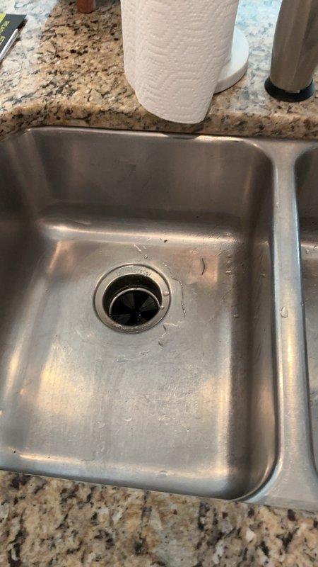 Completed garbage disposal installation in kitchen sink where no previous unit existed. Installed new disposal unit with mounting assembly and drain flange, requiring modification of existing drain piping underneath sink to accommodate the disposal connection. Adjusted P-trap and tailpiece configuration to ensure proper drainage and code-compliant installation.