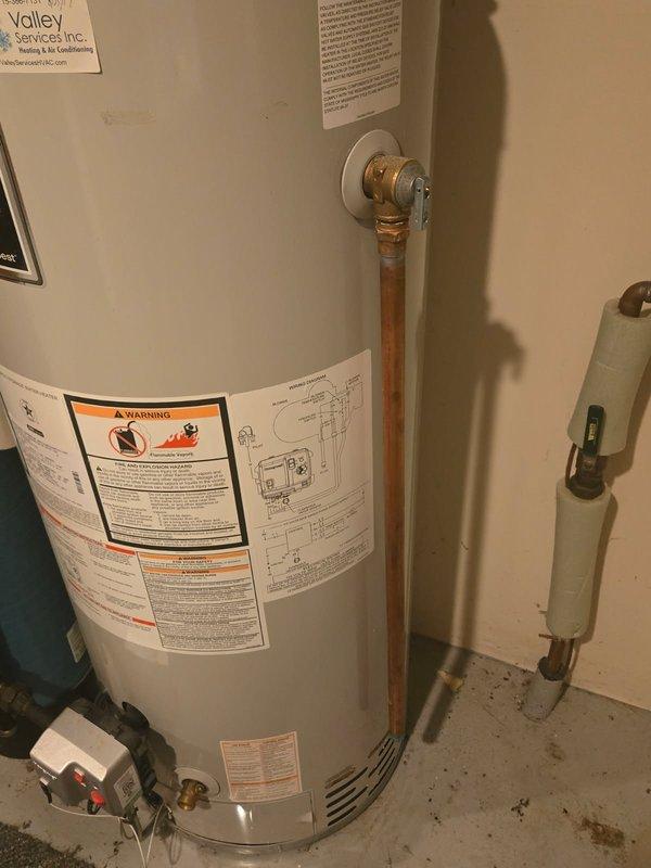 Responded to water heater leak from vertical copper discharge pipe. Upon inspection, identified temperature and pressure relief valve as source of drip. Verified system water pressure was within normal operating range to rule out excessive pressure as contributing factor. Replaced defective T&P relief valve with new unit and tested for proper operation and seal integrity. Unit is a Bradford White 40-gallon natural gas water heater, model RG1PV40S6N. System restored to normal operation with no active leaks detected upon completion.