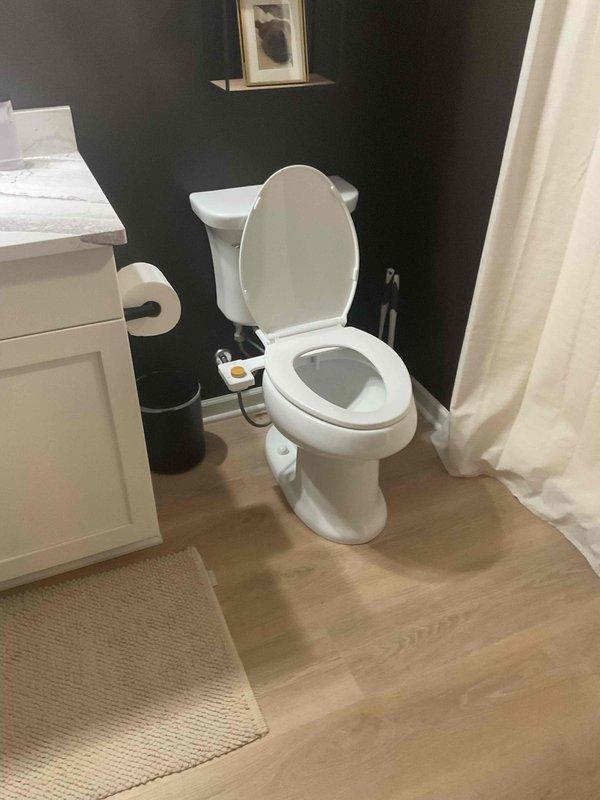 Completed comprehensive plumbing inspection of residential property including basement mechanical room and bathroom facilities. Inspected water treatment system consisting of green filtration tank and black brine tank, verified proper operation of water softener controls and PEX manifold distribution system, examined water heater connections and supply lines for leaks or corrosion, and assessed all visible plumbing infrastructure in utility area. Evaluated bathroom plumbing fixtures including toilet with bidet attachment, vanity connections, and shower/tub assembly to ensure proper function and identify any potential issues requiring attention.