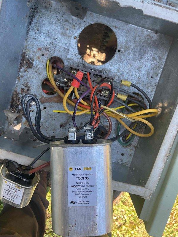 Completed comprehensive furnace and AC tune-up on aging HVAC system at recently purchased property. During inspection, identified multiple components nearing end of service life including rusty inducer motor, failing blower motor, and heat exchanger requiring monitoring. AC system found low on refrigerant charge. Gas valve threads stripped, preventing pressure testing capability. Cleaned flame sensor and verified seal level acceptable. Documented equipment condition with photos showing electrical components, capacitor, and ductwork. System operational but recommend planning for replacement due to age and cumulative wear of critical components.