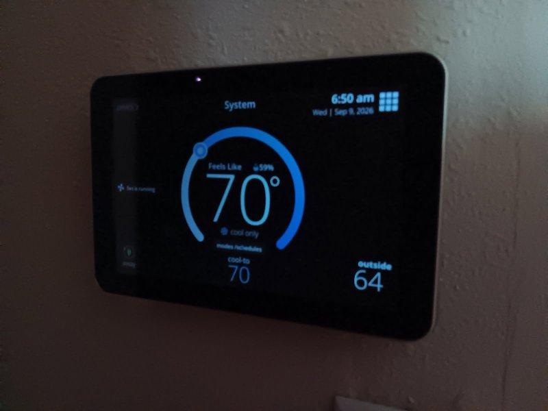 Responded to service call for AC and furnace tune-up with reported non-functional AC and blank thermostat screen. Upon arrival, diagnosed S30 thermostat with severely diminished display brightness making screen nearly unreadable without using phone camera to view. Accessed thermostat settings and verified brightness was set to maximum, but issue persisted indicating display failure. Contacted customer to discuss findings and recommended replacement with S40 thermostat model. Equipment tune-up deferred pending thermostat replacement, as further diagnostics and maintenance will be completed during return visit for thermostat installation.
