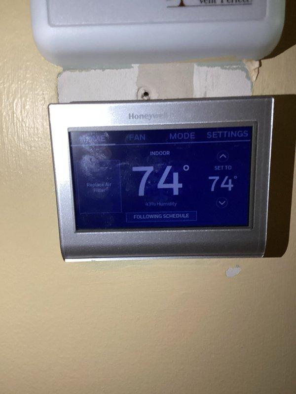 Completed routine maintenance and tune-up service on residential furnace and air conditioning system per maintenance agreement. Performed comprehensive inspection of HVAC equipment, verified thermostat operation showing 74°F setpoint with 43% humidity and proper scheduling function. Applied Hurlburt maintenance record label to equipment for service documentation and future reference tracking.