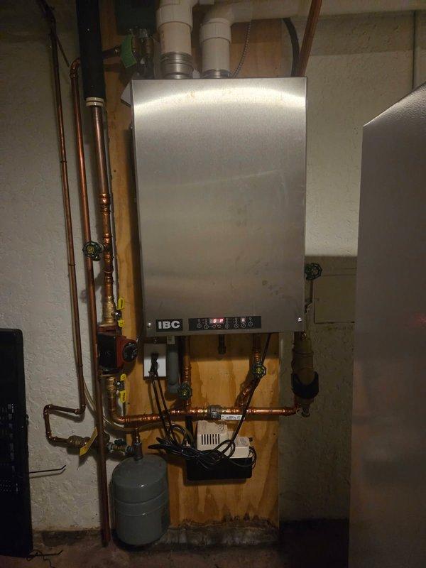 Responded to service call for IBC hot water boiler displaying low water pressure code and auto-fill malfunction. Upon arrival, confirmed system was experiencing low pressure and automatic fill valve was not functioning properly. Inspected and adjusted auto-fill valve to restore proper operation.

Performed comprehensive annual maintenance service on the boiler system. Disassembled and removed heat exchanger for thorough cleaning to remove scale buildup and ensure optimal heat transfer efficiency. Cleaned burner assembly and combustion chamber. Reassembled heat exchanger and verified all connections were properly secured.

Conducted full electrical system inspection, checking all control components, safety devices, and wiring connections. Verified proper operation of control board, circulator pump, and zone valves. Tested all safety switches and limit controls for proper functionality.

Started boiler and monitored through complete heating cycle. Verified system reached proper operating