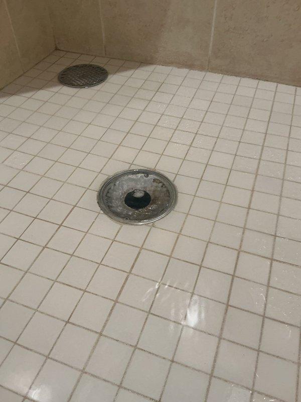 Responded to an upstairs shower drain backup. Upon arrival, performed diagnostic assessment and confirmed the shower was draining slowly and backing up when water was run. Utilized drain cable equipment to clear the obstruction in the shower drain line. Successfully removed a large accumulation of hair and debris that was causing the blockage. Tested the drain by running water and verified proper flow and drainage were restored. Attempted to perform a complimentary main line sewer scope as requested, but encountered camera equipment malfunction that prevented completion of the inspection. A follow-up visit will be required to complete the sewer line video inspection once equipment issues are resolved.