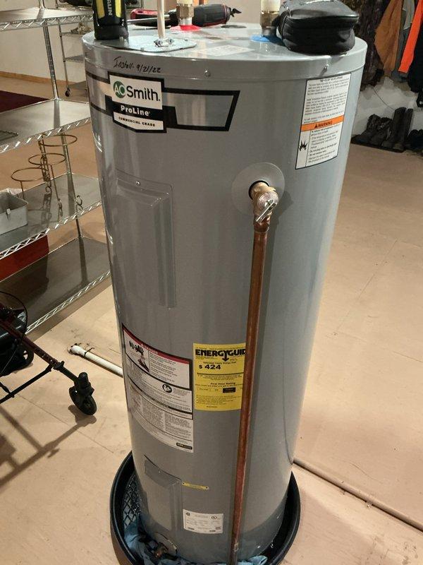 Responded to service call for non-functioning A.O. Smith ProLine 50-gallon electric water heater that was originally installed by our company four years prior. Upon arrival, determined that the unit was not operational due to homeowner's unfamiliarity with the peak time control box, which restricts water heater operation during high-demand electrical periods. Educated the new homeowners on the function and operation of the peak time control system. During inspection, identified a faulty temperature pressure relief valve that required replacement. Replaced the defective T&P relief valve with a new unit, covering the part under manufacturer warranty. Verified proper operation of the water heater system and confirmed adequate hot water production following repairs.