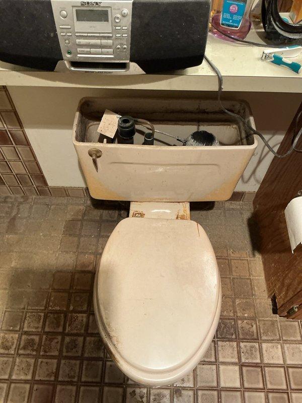 Responded to service call for malfunctioning toilet with failed internal flushing components. Removed tank lid to assess condition and found deteriorated fill valve, worn flapper, broken handle assembly, and compromised supply line requiring replacement. Completed full flush mechanism rebuild by installing new fill valve assembly, flapper valve, tank handle, and water supply line. Tested system operation to ensure proper fill cycle, flush function, and verify no leaks at connections.