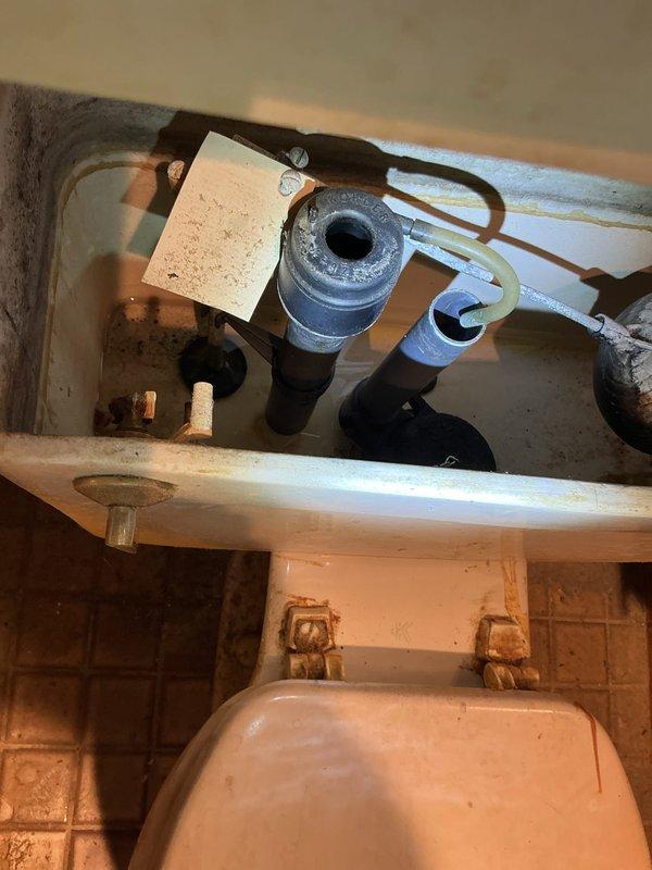 Responded to service call for malfunctioning toilet with failed internal flushing components. Removed tank lid to assess condition and found deteriorated fill valve, worn flapper, broken handle assembly, and compromised supply line requiring replacement. Completed full flush mechanism rebuild by installing new fill valve assembly, flapper valve, tank handle, and water supply line. Tested system operation to ensure proper fill cycle, flush function, and verify no leaks at connections.