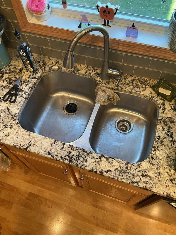 Responded to a kitchen sink stoppage complaint at a residential property. Upon arrival, performed diagnostic assessment which revealed the drain was filling with water after brief usage, indicating a blockage located downstream of the trap assembly.

Deployed flex shaft cable machine to clear the obstruction, running the cable through the full accessible length of the kitchen drain line. Successfully removed the blockage and restored proper drainage flow. Following mechanical clearing, inserted drain camera scope through the line to conduct visual inspection of the pipe interior, confirming complete removal of debris and verifying no remaining obstructions were present in the system.

Conducted final operational testing by running water through both basins of the double-basin stainless steel sink while monitoring drain performance. Verified proper flow rate and confirmed no backup or slow drainage conditions remained. All fixtures returned to normal operating condition upon completion 