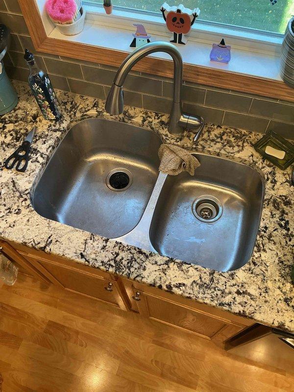 Responded to a kitchen sink stoppage complaint at a residential property. Upon arrival, performed diagnostic assessment which revealed the drain was filling with water after brief usage, indicating a blockage located downstream of the trap assembly.

Deployed flex shaft cable machine to clear the obstruction, running the cable through the full accessible length of the kitchen drain line. Successfully removed the blockage and restored proper drainage flow. Following mechanical clearing, inserted drain camera scope through the line to conduct visual inspection of the pipe interior, confirming complete removal of debris and verifying no remaining obstructions were present in the system.

Conducted final operational testing by running water through both basins of the double-basin stainless steel sink while monitoring drain performance. Verified proper flow rate and confirmed no backup or slow drainage conditions remained. All fixtures returned to normal operating condition upon completion 