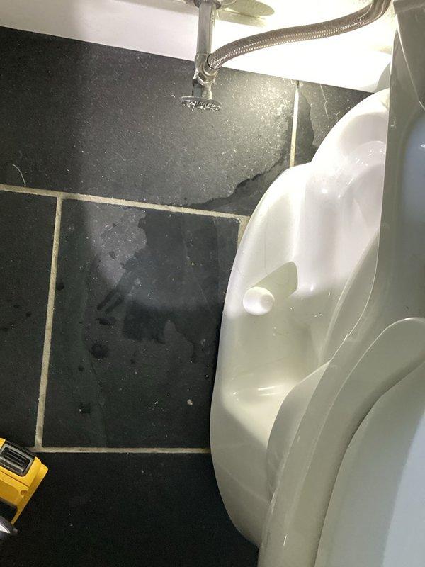 Responded to a water leak originating from an upstairs toilet that was causing damage to the lower level. Upon arrival, identified active water pooling on the bathroom floor adjacent to the toilet fixture. Removed the toilet from its mounting position to inspect the underlying flange and wax seal. Discovered a broken toilet flange that had compromised the seal integrity, allowing water to escape during toilet use and flush cycles. Removed the damaged flange and installed a new replacement flange to manufacturer specifications. Reset the toilet onto the new flange with a fresh wax ring seal, ensuring proper alignment and secure mounting. Reconnected the water supply line and tested the toilet through multiple flush cycles to verify leak elimination and proper drainage function.