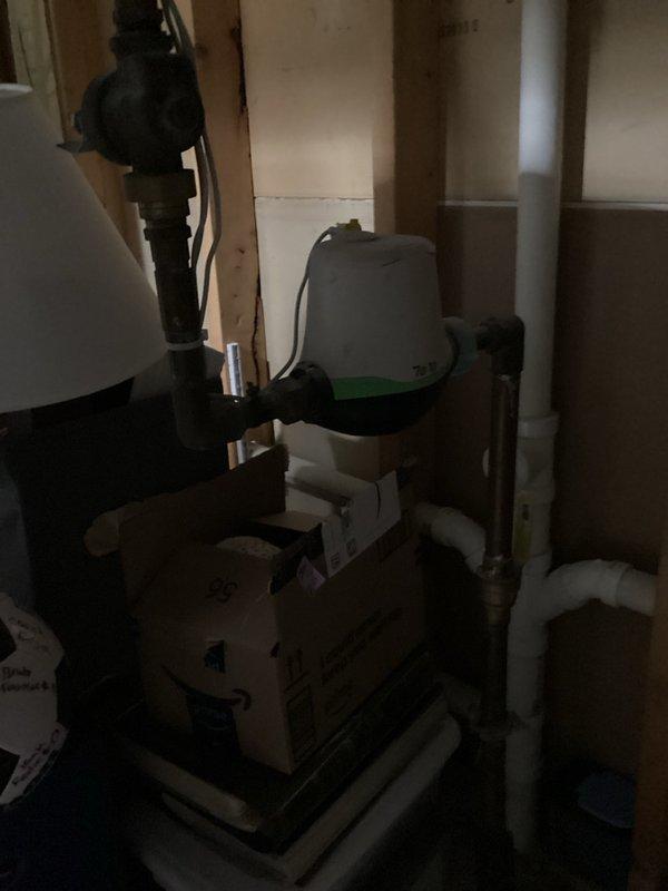 Responded to service call for shower valve replacement in owner-occupied residence. Upon arrival, main water supply was shut off as customer was unable to remove existing valve cartridge from wall assembly. Successfully extracted failed Delta cartridge from shower valve body and installed customer-supplied replacement cartridge. Tested operation and restored water service to home. 

During inspection, noted evidence of significant hard water conditions affecting plumbing system. Offered water quality assessment and treatment options to address mineral buildup concerns, which customer declined at this time. Documented water heater installation date of October 9, 2017, observed during basement utility room access. All plumbing connections secured and system returned to normal operation with no leaks detected.