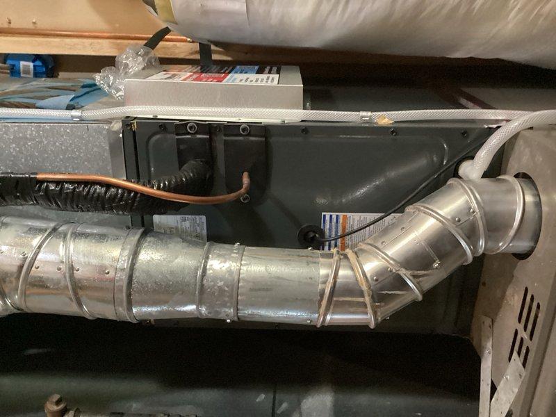 Responded to no cooling call with blank thermostat display. Upon inspection, found improperly installed Dragonfly module with loose wiring connections throughout, including detached C-wire connections. Module was not mounted and control board was unsecured inside enclosure. Remounted control board and temporarily bypassed Dragonfly module to restore system operation. Control board displaying 4-flash diagnostic code indicating sensor replacement required. Recommended replacement of both sensor and Dragonfly module to complete proper repair.