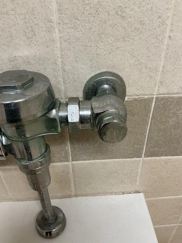 Responded to callback for commercial urinal continuously running water despite previous sensor cleaning. Performed thorough investigation of flush valve assembly and determined sensor cleaning was insufficient to resolve issue. Urinal observed flushing intermittently on its own, indicating internal flush valve failure. Ordered replacement flush valve assembly and temporarily shut off water supply to unit to prevent water waste until new valve can be installed.