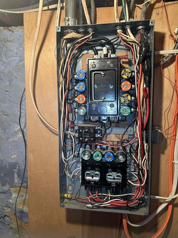 Responded to no-cooling complaint on recently installed central air conditioning system. Upon arrival, confirmed indoor unit operating but outdoor condenser fan not running, resulting in approximately 10-degree temperature differential from setpoint. Diagnostic inspection revealed water heater and air conditioning unit improperly sharing a single 15-amp circuit in electrical panel, causing circuit breaker failure under combined load. Replaced blown fuse and restored power to system. Verified air conditioning unit returned to normal operation with outdoor fan functioning properly. Documented electrical panel configuration with photos showing inadequate circuit capacity for dual appliance load. Advised homeowner that licensed electrician must be scheduled to install dedicated circuit with appropriate amperage for air conditioning unit to prevent recurring breaker trips and ensure code-compliant installation.
